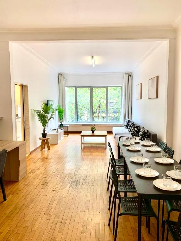 a large living room with a table and chairs at Belga Apartment 3 bedrooms. in Antwerp