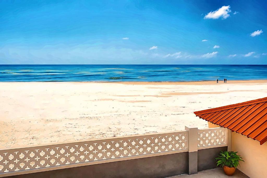 a view of the beach from the balcony of a condo at Uroa Beachfront Apt Direct Sand in Uroa