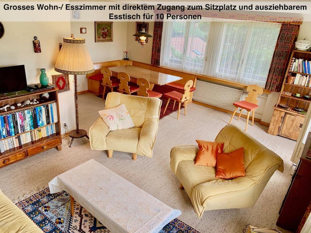 a living room with two couches and a dining table at Chalet Panorama in Adelboden