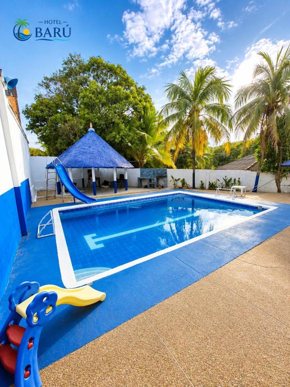 a swimming pool with a slide next to a pool at Hotel Barú Melgar in Melgar