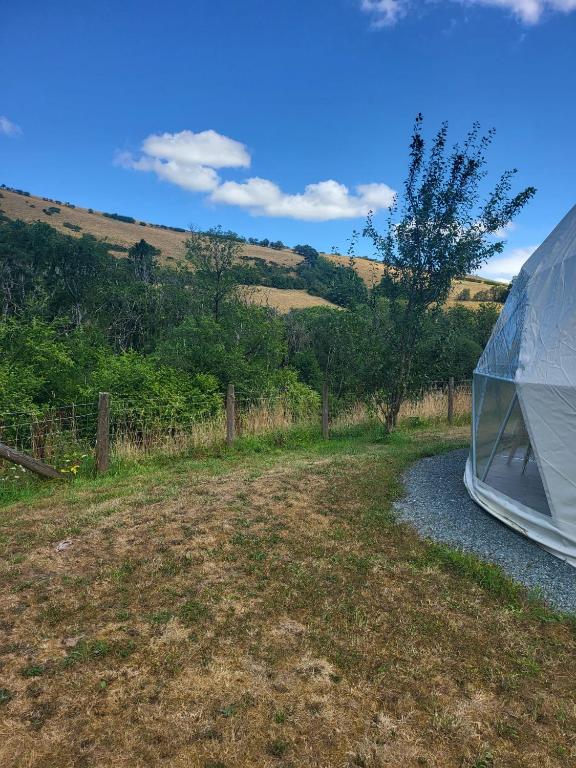 a tent sitting on the side of a gravel road at Pen-Y-Fan Glamping - Luxury Geodomes in Sennybridge