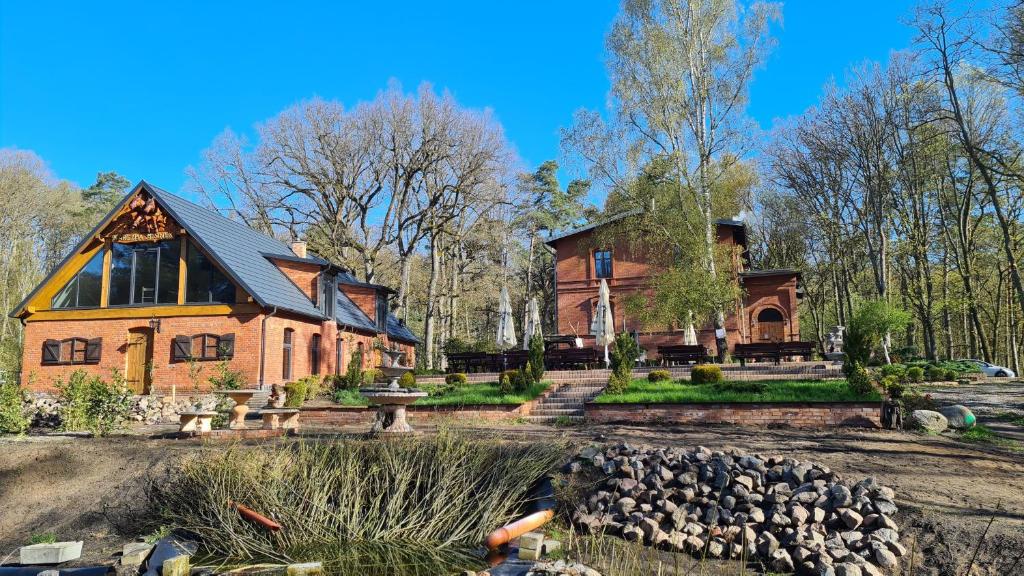 a large brick house with a yard in front of it at Dwór Mysinek in Grabowiec