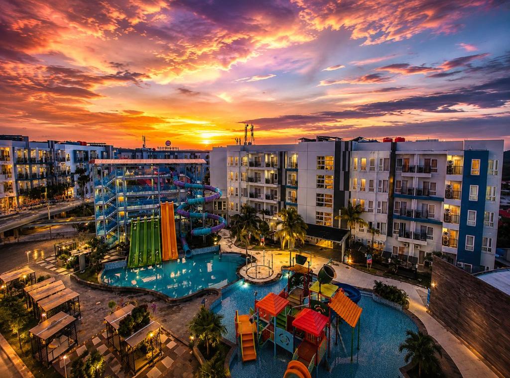 a view of a resort with a pool and buildings at Pentapolis Apartment Balikpapan Superblock LT4 in Balikpapan