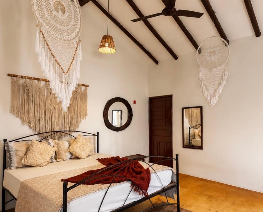 a bedroom with a bed and a mirror at Lax Stays Morjim by SevenTales in Morjim