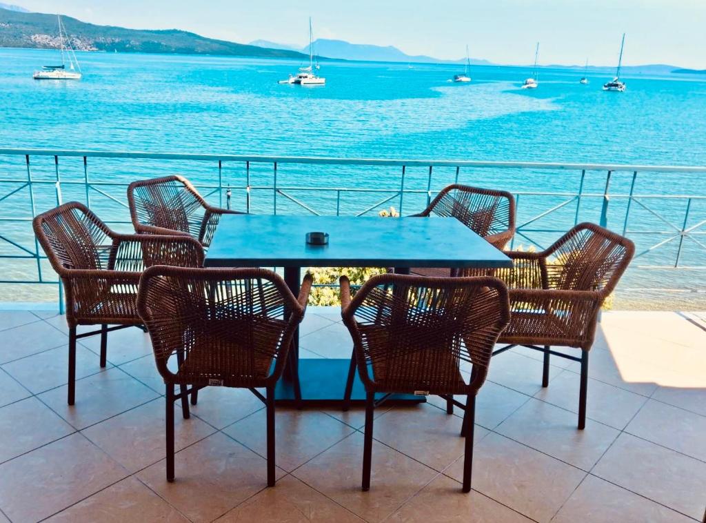a table and chairs with a view of the water at SALTY BREEZE Beachfront Apartment in Lygia