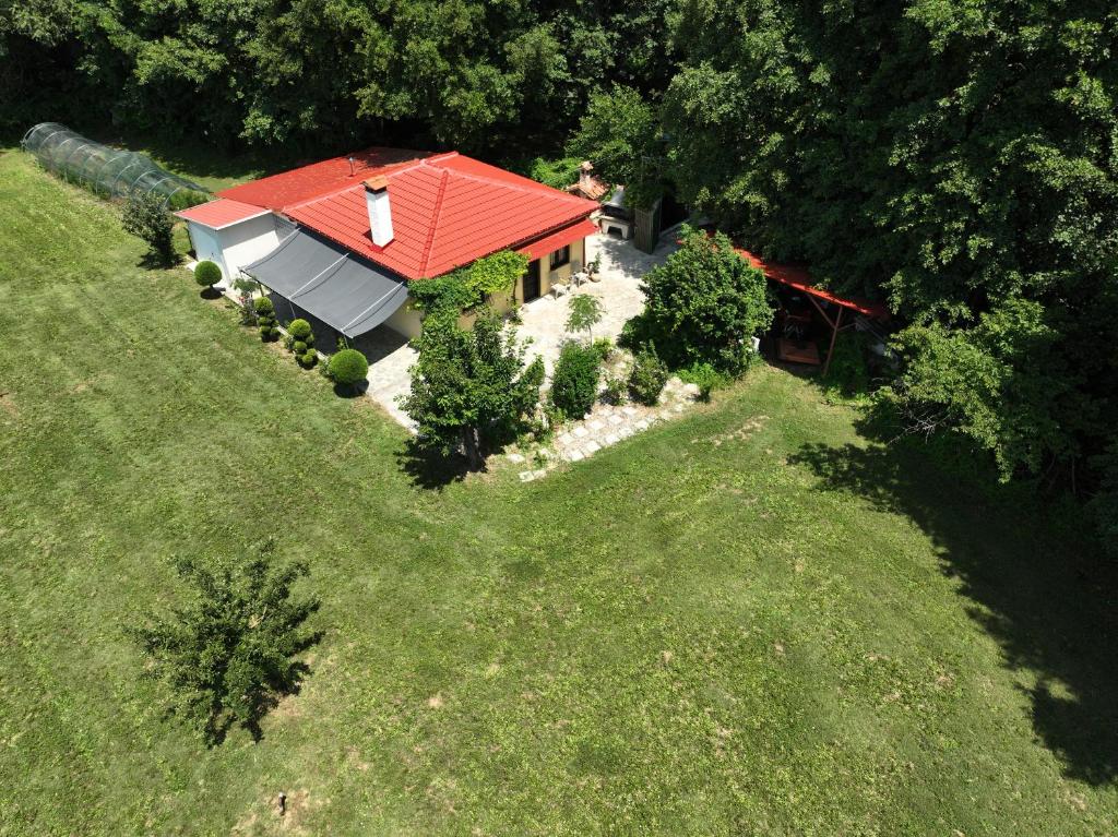 an overhead view of a house with a red roof at River side house in Kastoria