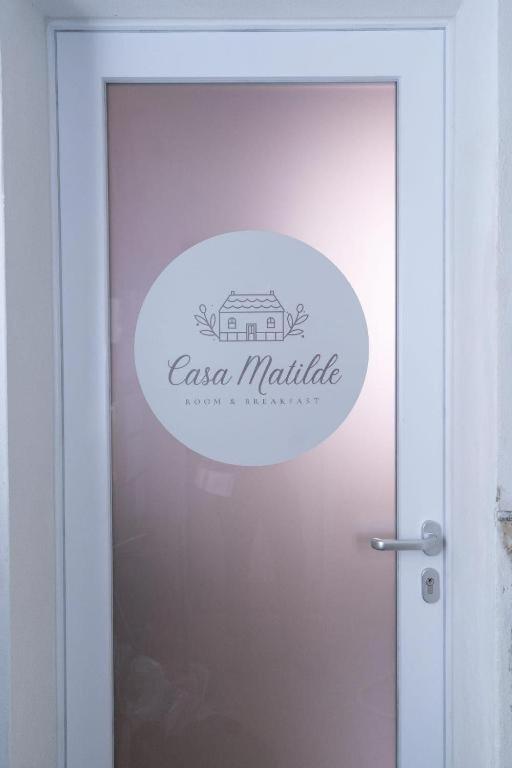 a sign on the door of an entrance to an apartment at Casa Matilde Rooms & Apartment in Bazzano Bologna