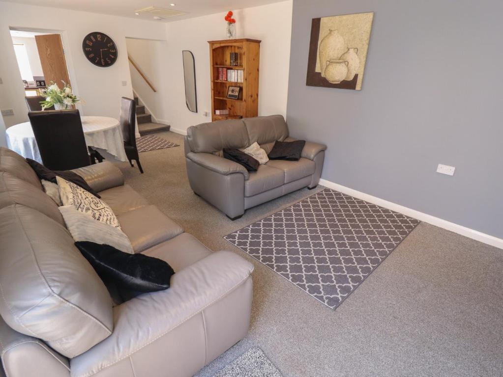 a living room with a couch and a table at Number 3 Old Boston Road in Lincoln
