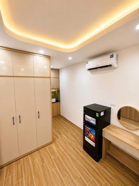 an empty room with a kitchen with a counter at Happy Hotel Phu Tho 