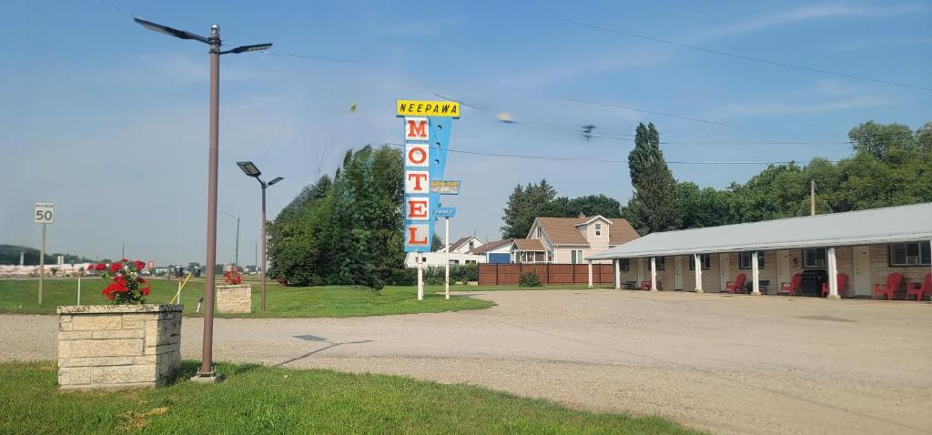 a large motel sign in front of a building at Neepawa Motel in Neepawa
