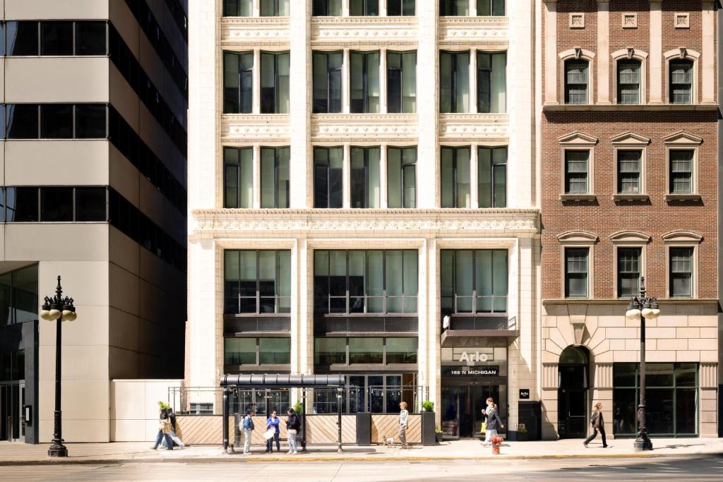 people walking on a street in front of buildings at Arlo Chicago in Chicago