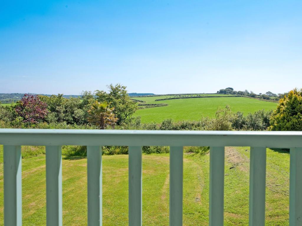 a view from the balcony of a house with a green field at Holly Apartment - Uk49299 in Woolfardisworthy