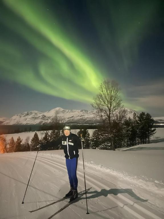 a person is standing on skis in the snow at Stetind Skicamp in Lyngen