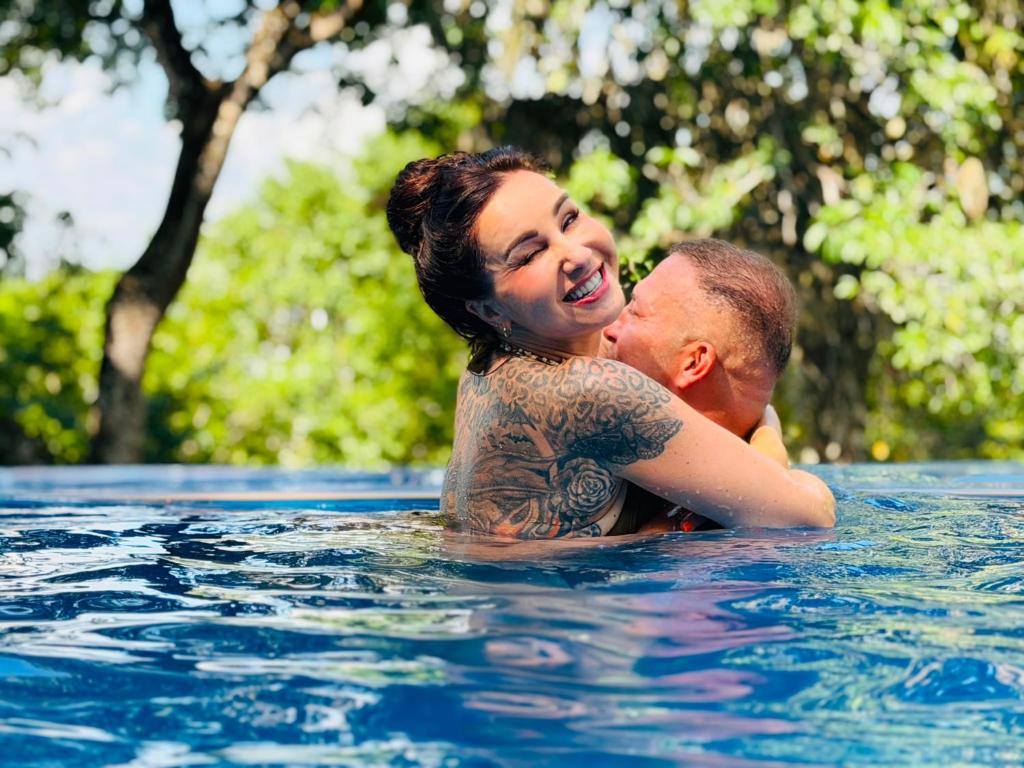 a man and a woman in a swimming pool at Green Hill Paradise Villa in Unawatuna
