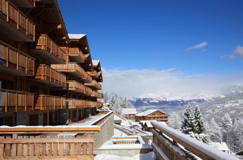 a view from the balcony of a resort in the snow at Dent Blanche Resort - TemptingPlaces Collection in Hérémence