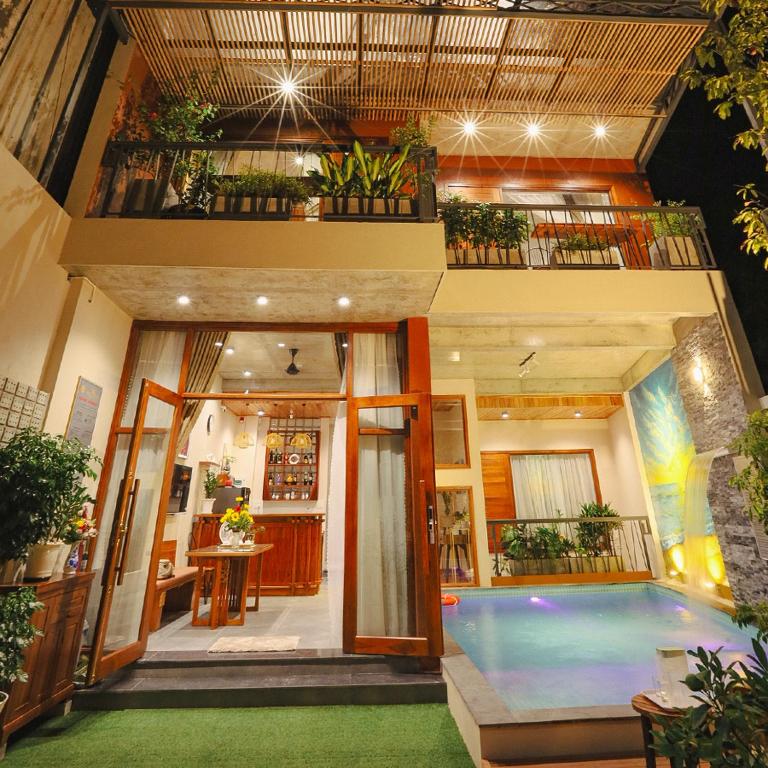 a house with a swimming pool in front of it at DQ Peaceful Villa in Thôn Dương Xuân Hạ