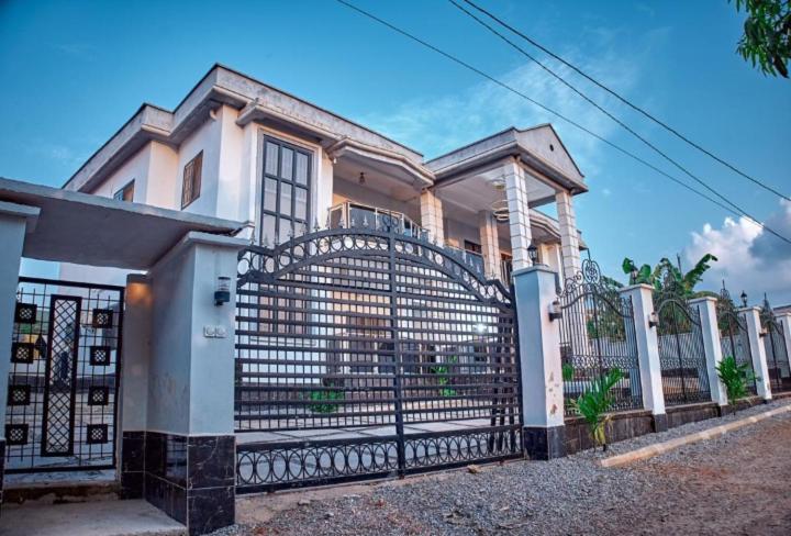 a house with a gate in front of it at Westtzs Home I in Yaoundé