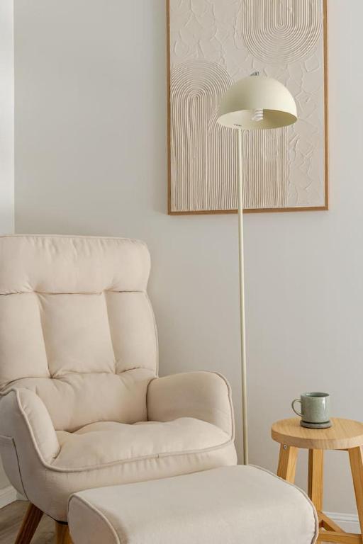 a living room with a chair and a lamp at Margate Beach Studio 3 in Redcliffe
