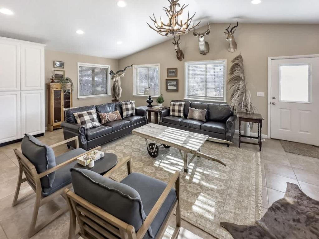 a living room with a couch and a table at MTN Meadow Retreat near PC in Peoa