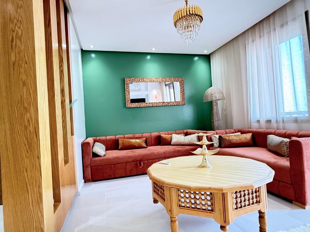 a living room with a couch and a table at Riad Marrakech, oasis apartment in Marrakesh