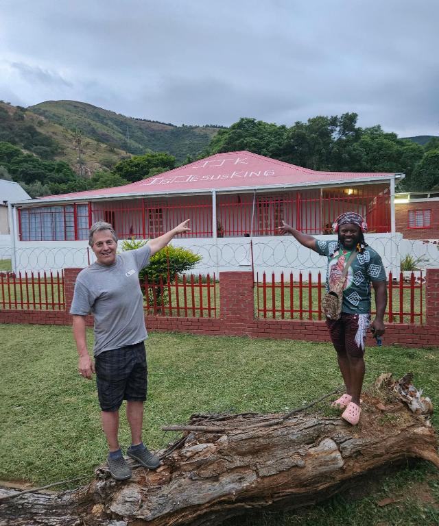 a man and a woman standing on a tree log at JJK free Breakfast in Barberton