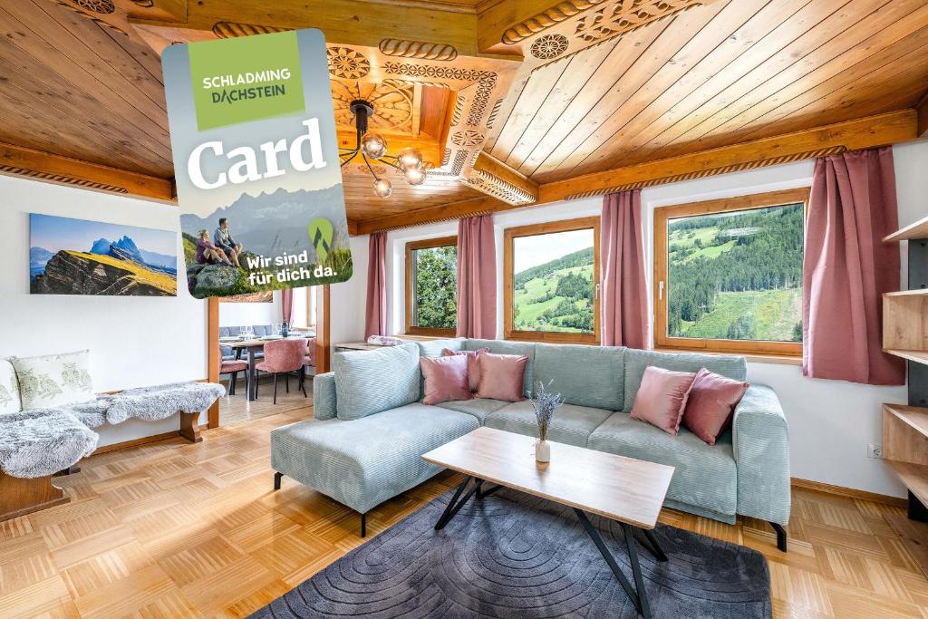 a living room with a couch and a table at Chalet BergMoment - by myNests in Rohrmoos