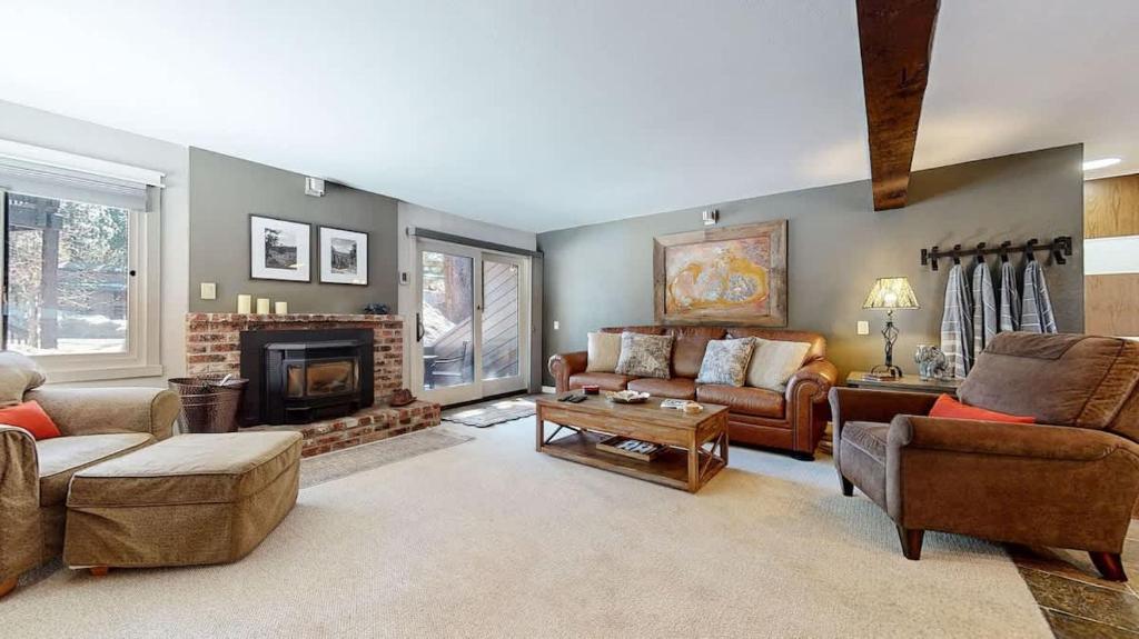 a living room filled with furniture and a fireplace at Mountain Condo | Spa Pool and Ski Shuttle Access in Mammoth Lakes