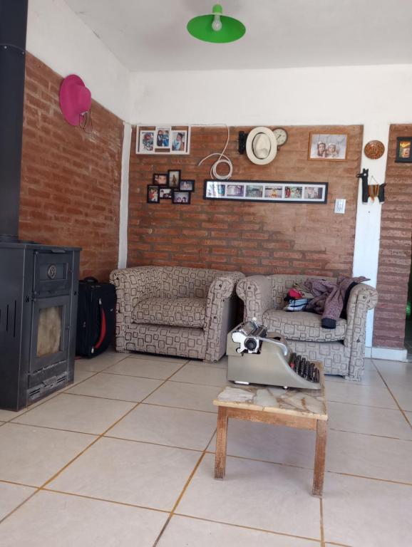 a living room with a table with a camera on it at Cerro de sol in Salsipuedes