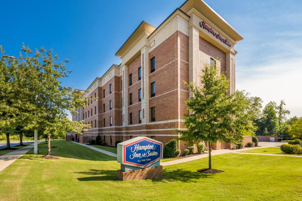 a large brick building with a sign in front of it at Hampton Inn & Suites By Hilton Knightdale Raleigh in Raleigh