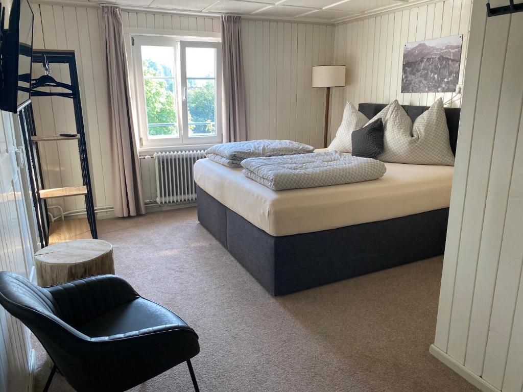 a bedroom with a large bed and a chair at Goldener Adler 
