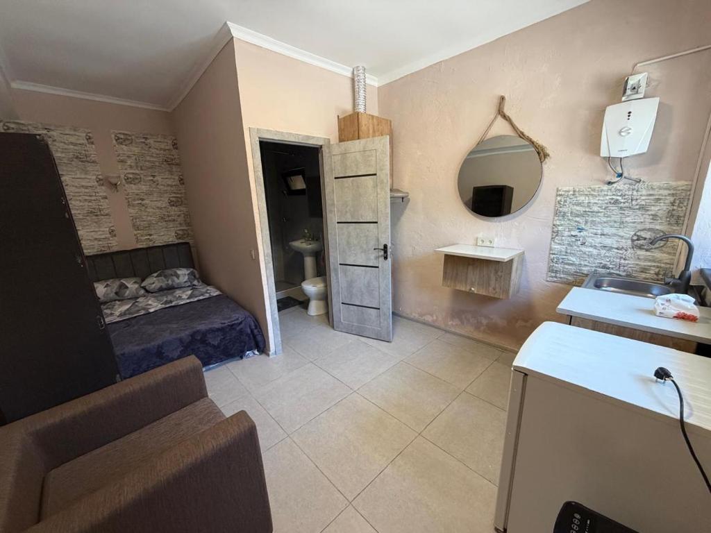 a small bathroom with a bed and a sink at Kond studio in Yerevan