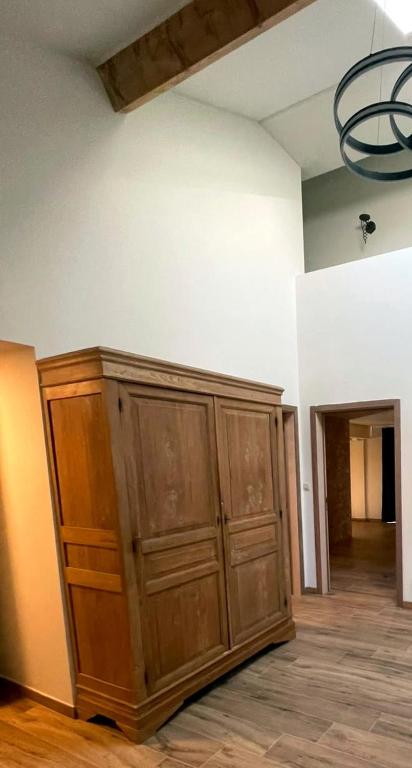 a room with a large wooden cabinet in a room at Maison Campagnard in Voeren