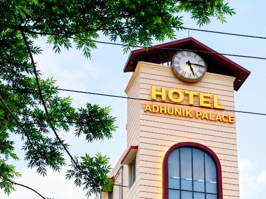 a hotel with a clock on top of a building at Adhunik palace in Keonjhargarh