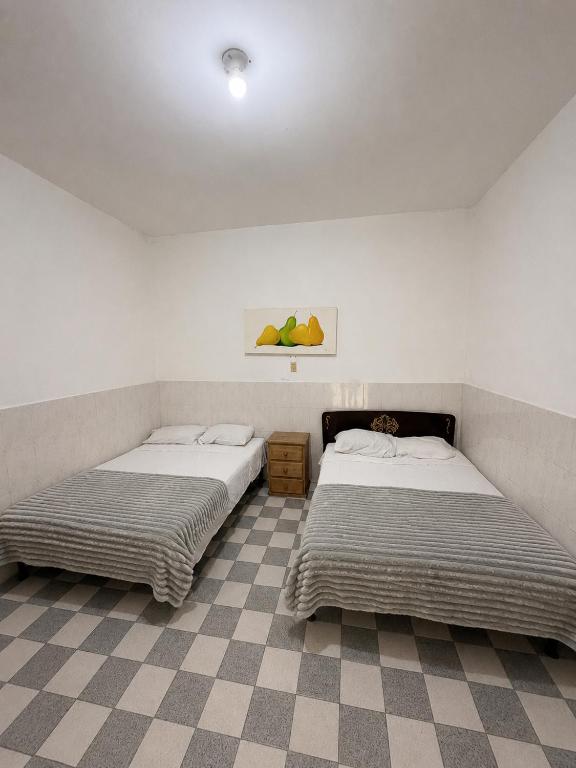 two beds sitting next to each other in a room at Los Olivos in Atlixco