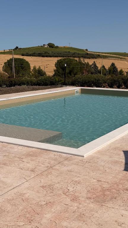 a swimming pool with blue water in the middle at Feudi di Bisaccia in Montenero di Bisaccia