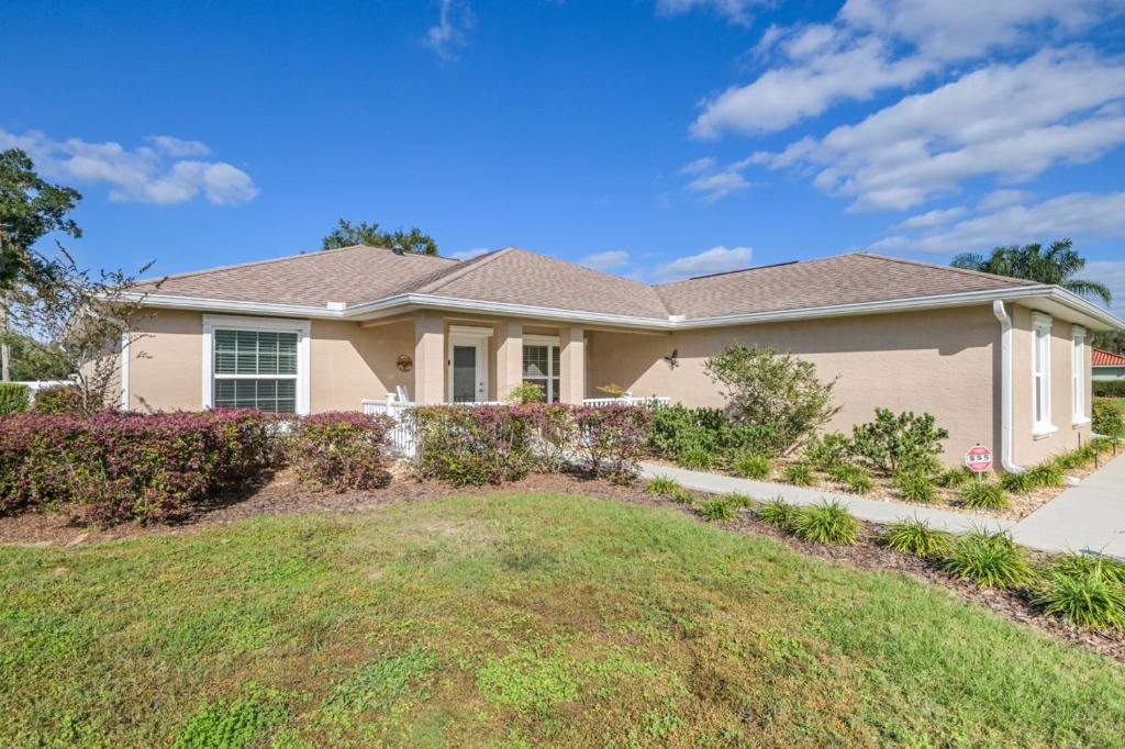 a house with a lawn in front of it at Withlacoochee Trail Getaway - Private Pool - 3bedrooms in Inverness