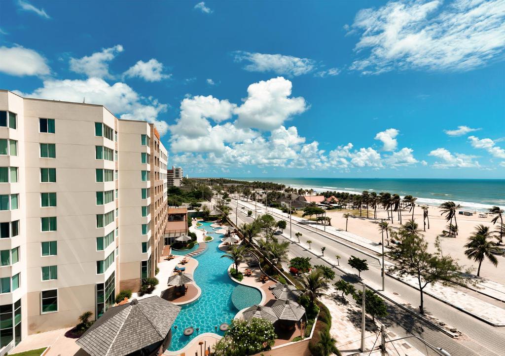 an aerial view of a resort with a swimming pool and the beach at Gran Mareiro Hotel in Fortaleza