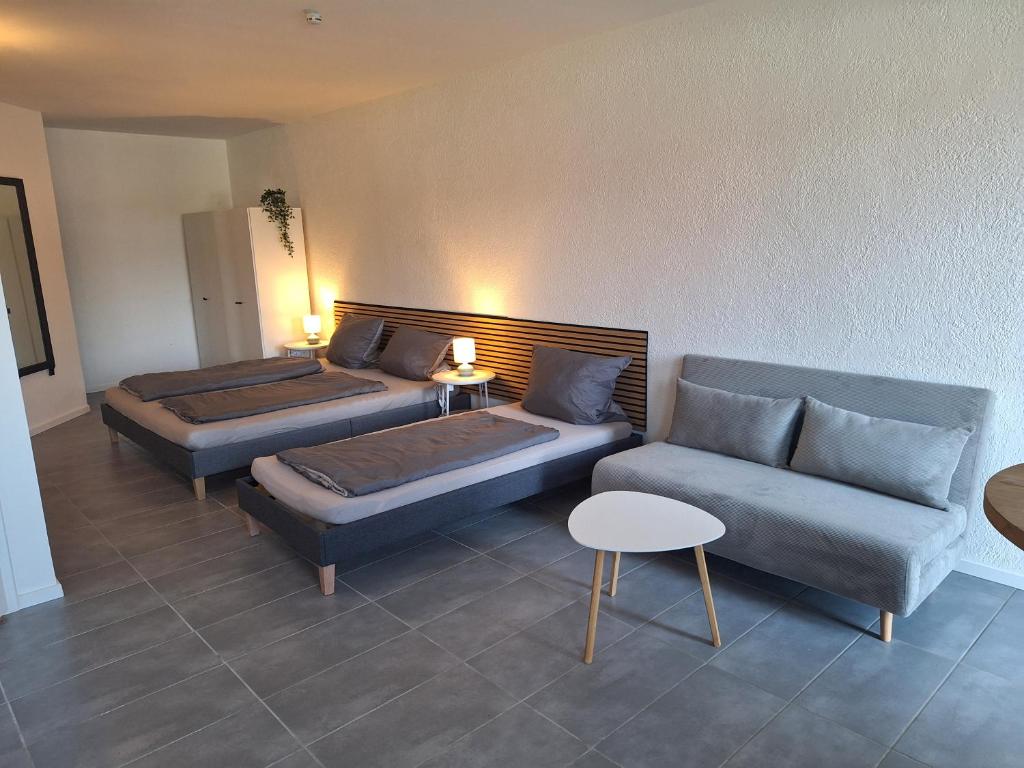 a hotel room with two beds and a couch at Apartment am Gestütswegs EG 2 in Alt Krenzlin