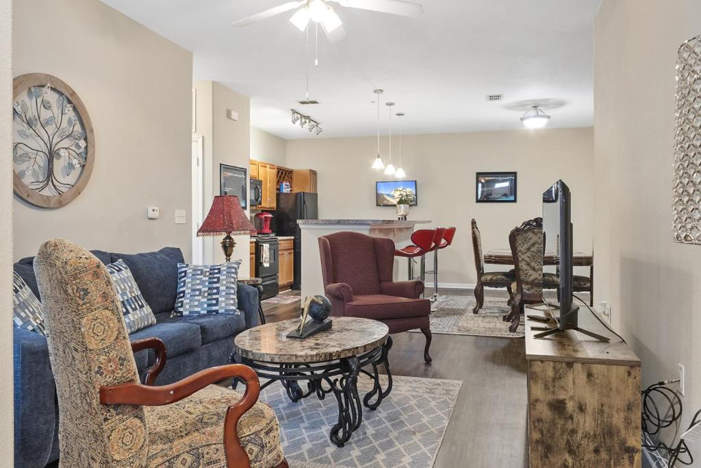 a living room with a blue couch and chairs at Mid-City Serenity Oasis in Huntsville