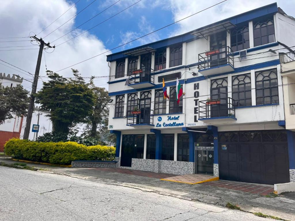 a blue and white building on the side of a street at Hotel La Castellana in Manizales