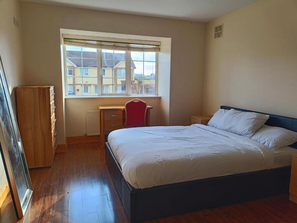a bedroom with a bed and a window at Ideal Guest Home in Waterford