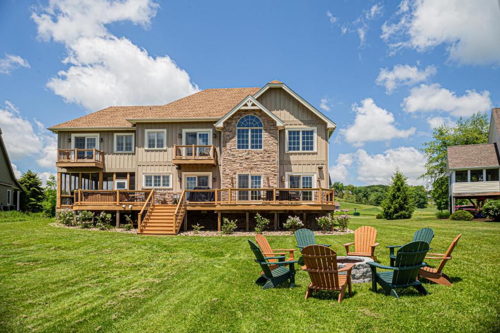 a large house with chairs and a table in the yard at Limitless Joy in Swanton