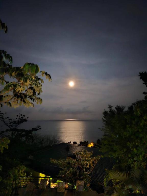 a full moon over the ocean at night at Sunshine Sanctuary Boutique Jungle Lodge in Montezuma