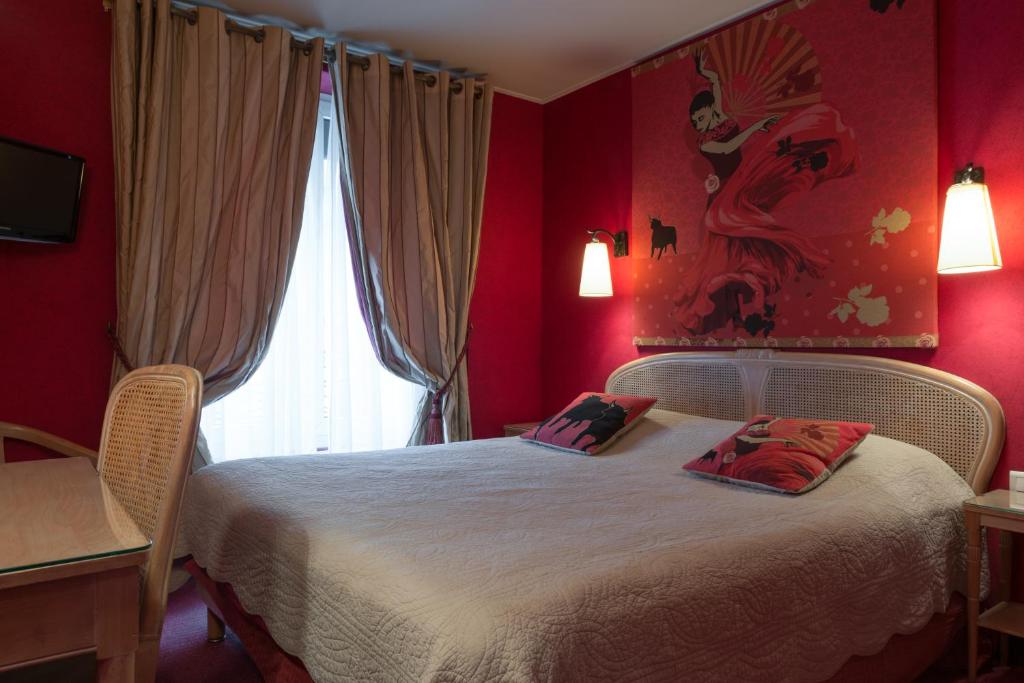 a red bedroom with a bed with two pillows on it at Neuilly Park Hotel in Neuilly-sur-Seine