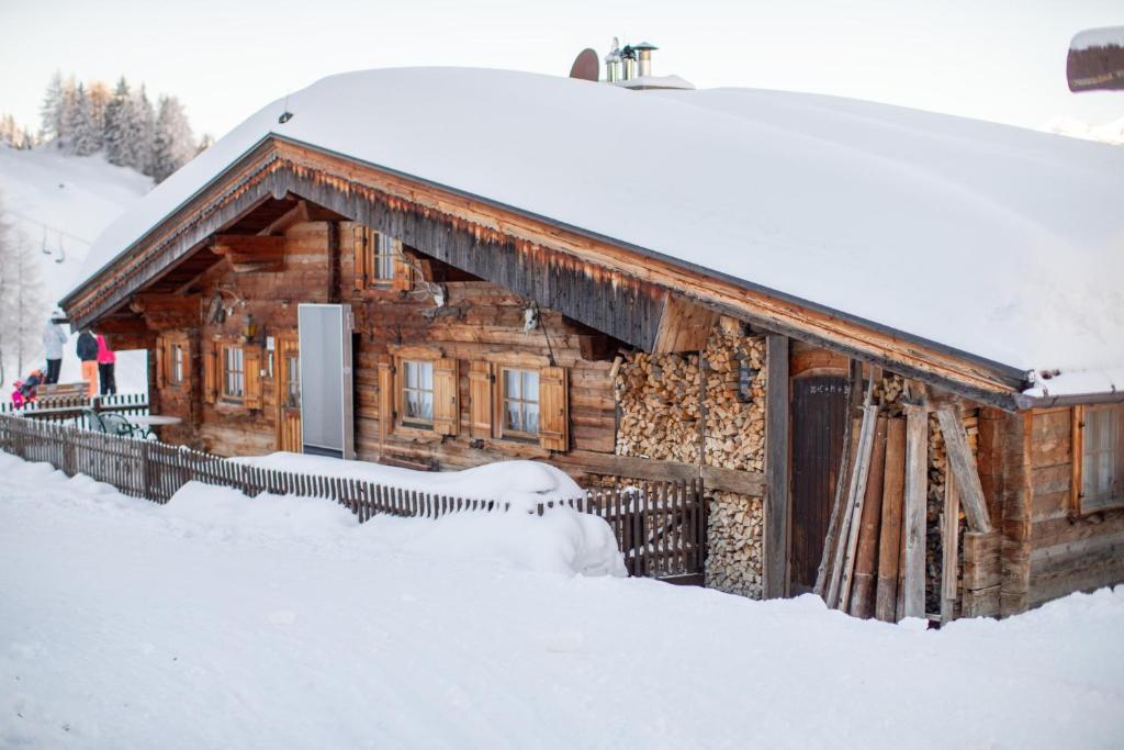 a log cabin covered in snow in the snow at Hütte Wilfried in Hainzenberg