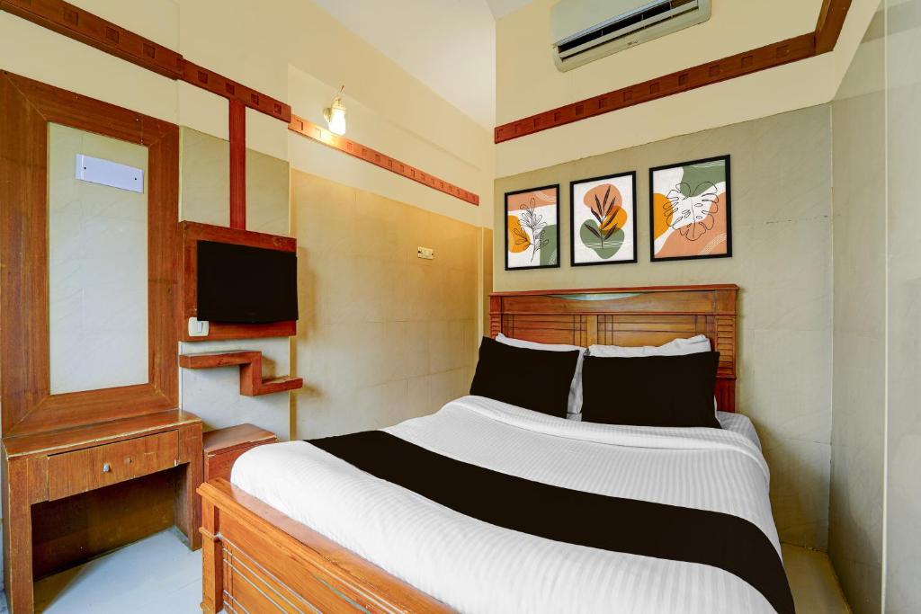 a bedroom with a large bed and a television at Hotel O Stay First in Coimbatore