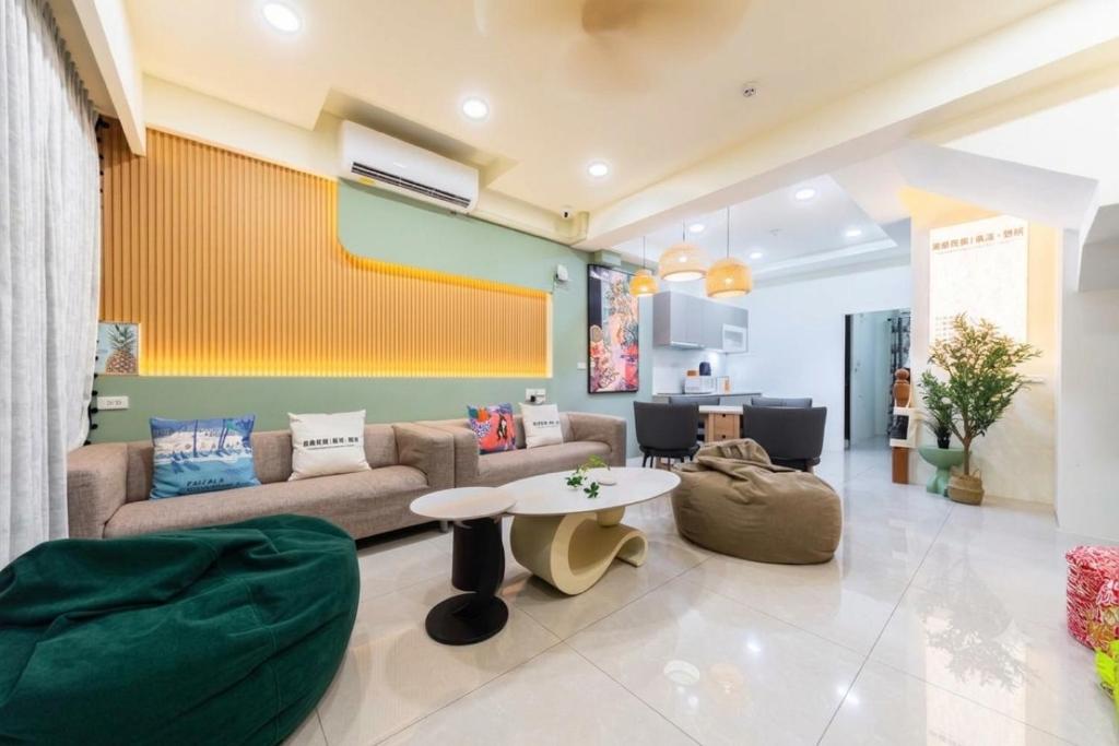 a living room with a couch and a table at 原森民宿B&b包棟最佳選擇 in Wujie
