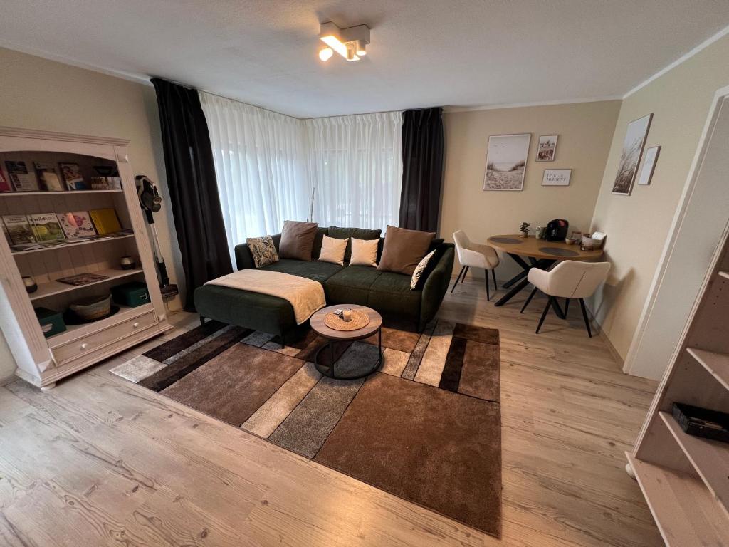 a living room with a couch and a table at Ferienwohnung Stoll - modern, mit Ausblick & Grill in Idar-Oberstein