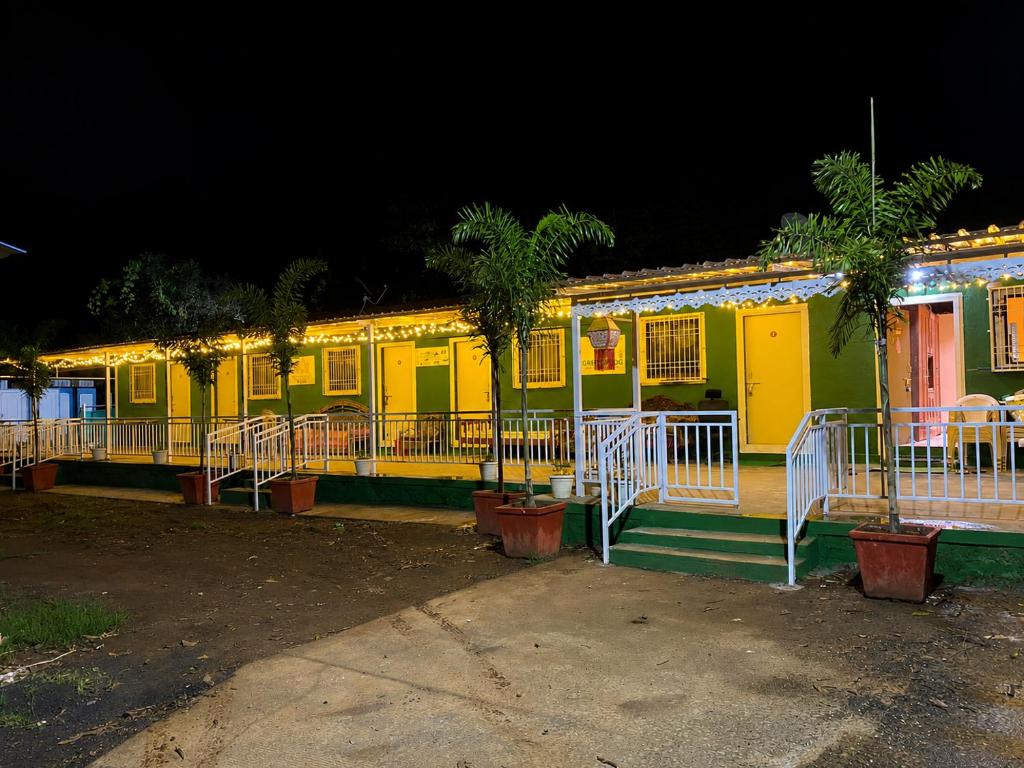 a row of brightly colored houses at night at Green Fog Guesthouse in Lonavala