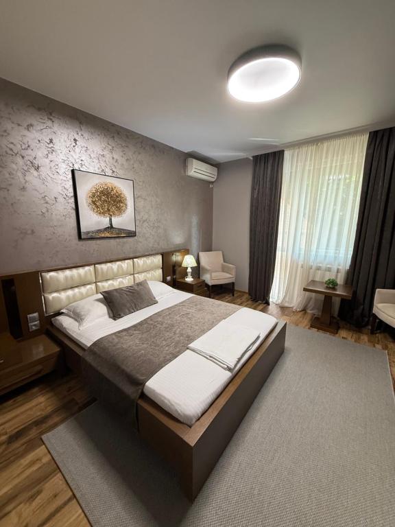 a bedroom with a large bed in a room at Motel Eros in Sandanski